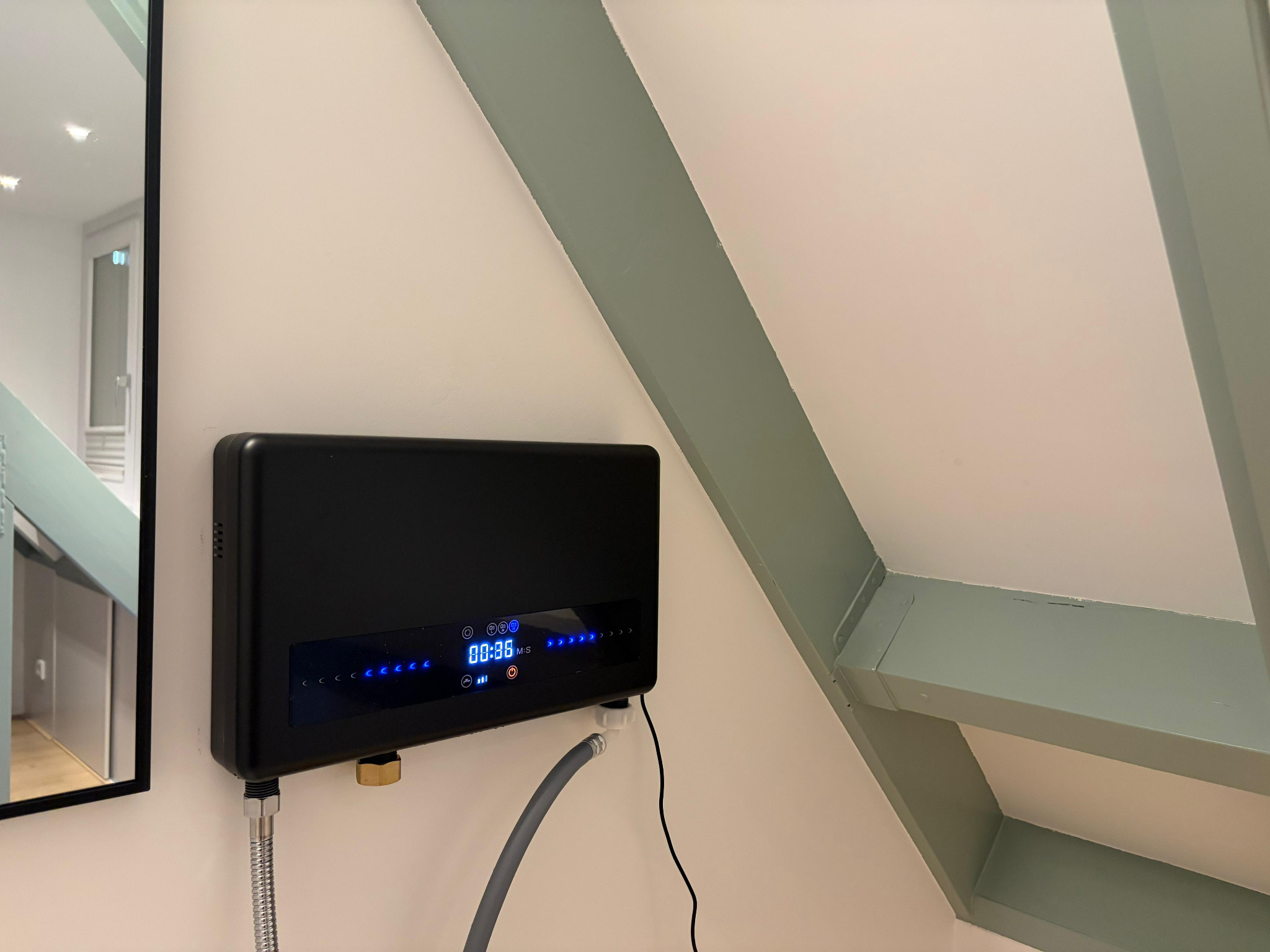 Black LYTO₃RA photographed from an angle in an actual installation, with its front controls and connections visible